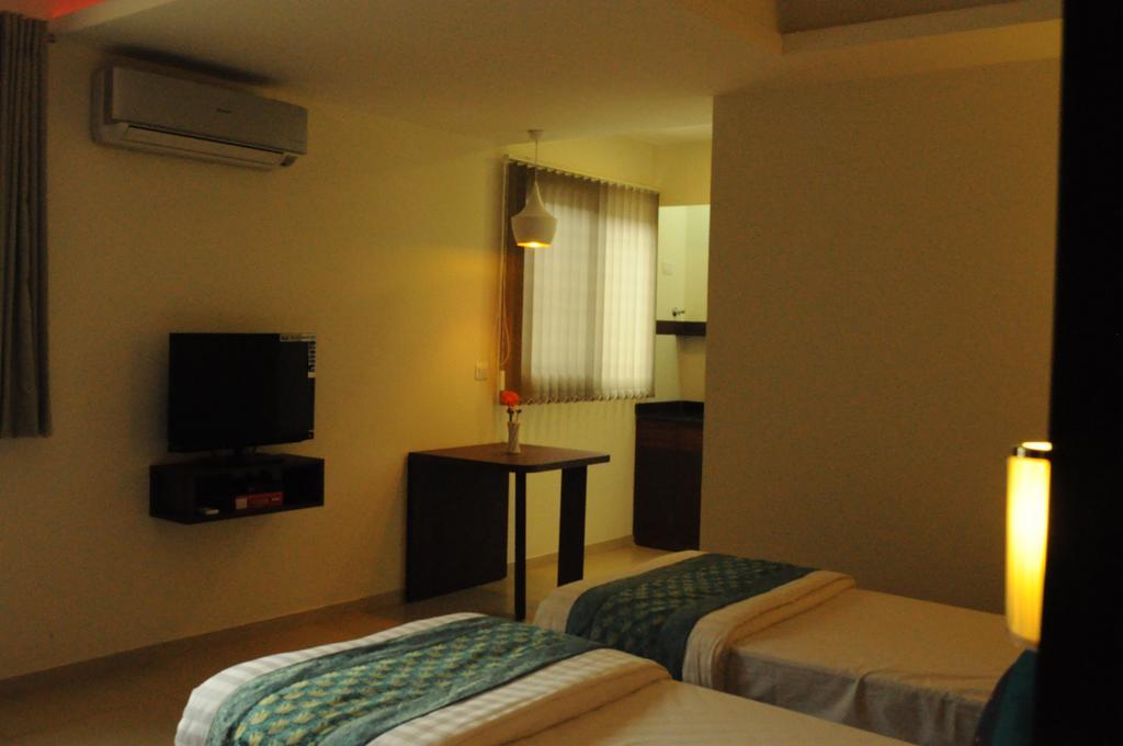 Ixora Suites Бенґалуру Номер фото